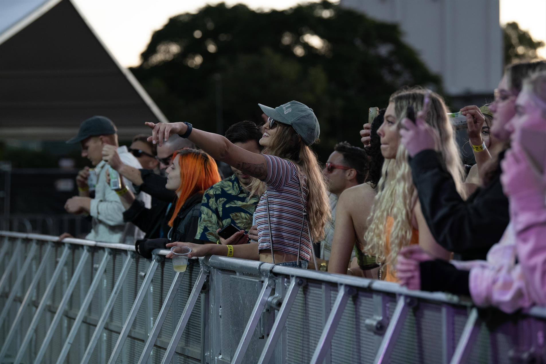 A woman standing in a crowd at a music festival.