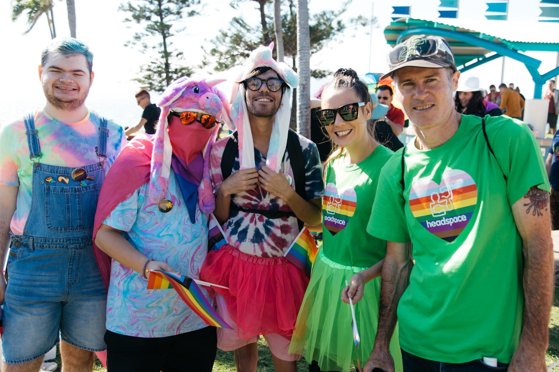 A group of people wearing colourful clothes posing for a photo.