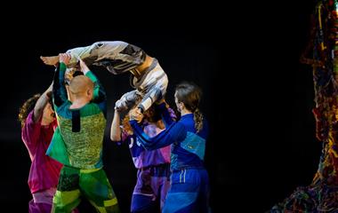 A group of performers dancing on stage.