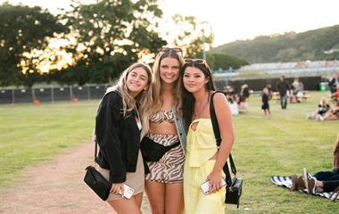 Three females at a music festival.